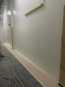 Repairs on white panel walls in progress