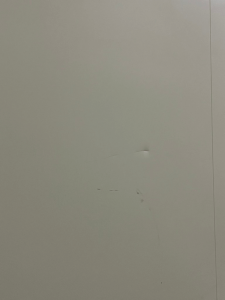 Marks and dents on white panel